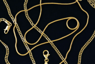 Gold,Chains,On,Blue,Felt,Texture,Closeup