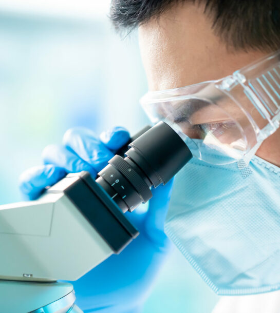 Asian,Microbiologist,Biotechnology,Researcher,Or,Medical,Worker,Look,Microscope,In